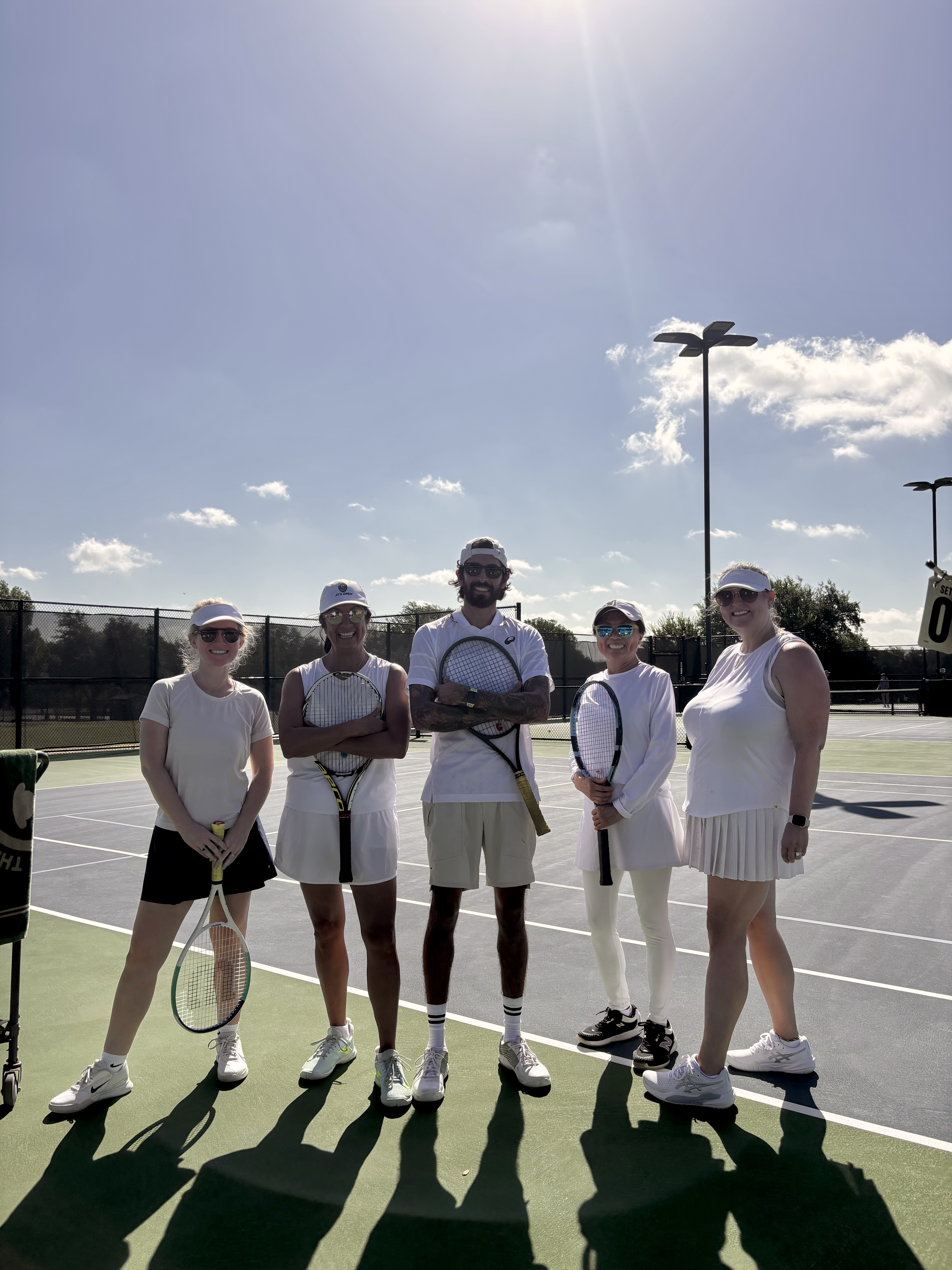 Coach Aaron with players after a doubles clinic in Austin